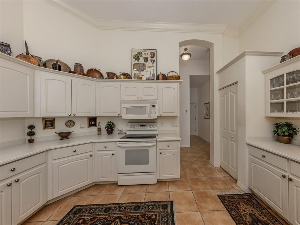 764 Sawgrass Bridge Road Venice, FL 34292 - Photo 13 of 60 a kitchen with a sink stove and cabinets