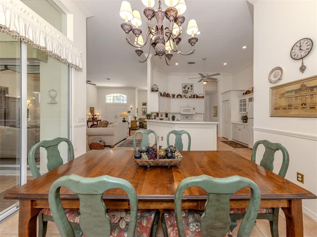 764 Sawgrass Bridge Road Venice, FL 34292 - Photo 14 of 60 a view of a dining room with furniture and chandelier