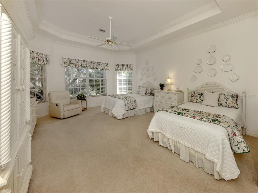 764 Sawgrass Bridge Road Venice, FL 34292 - Photo 15 of 60 a spacious bedroom with two beds and large window
