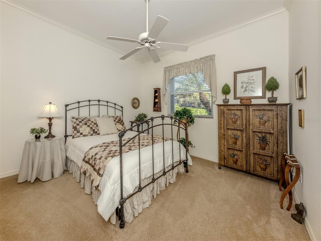 764 Sawgrass Bridge Road Venice, FL 34292 - Photo 19 of 60 a spacious bedroom with a bed and ceiling fan