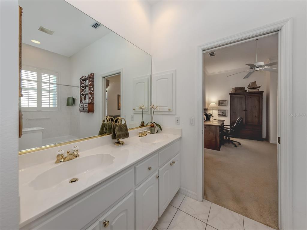 764 Sawgrass Bridge Road Venice, FL 34292 - Photo 22 of 60 a en suite bathroom with a double vanity sink and mirror