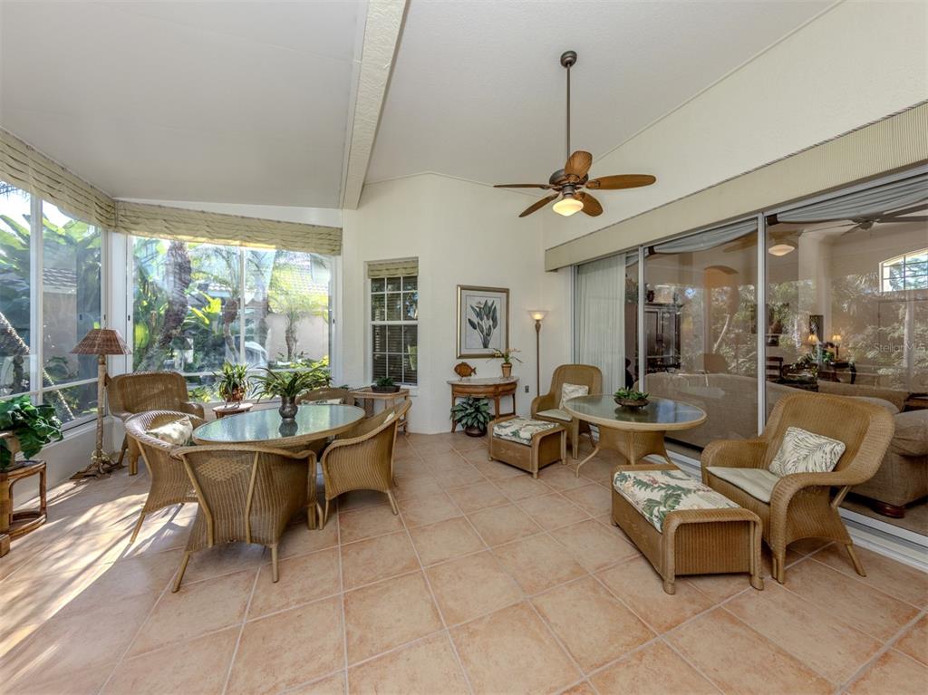 764 Sawgrass Bridge Road Venice, FL 34292 - Photo 24 of 60 a living room with couches a fireplace and a dining table with garden view