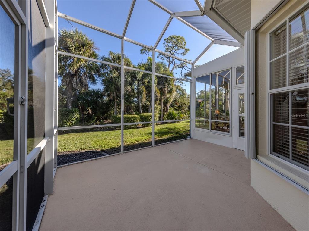 764 Sawgrass Bridge Road Venice, FL 34292 - Photo 27 of 60 a view of a porch with furniture and floor to ceiling window
