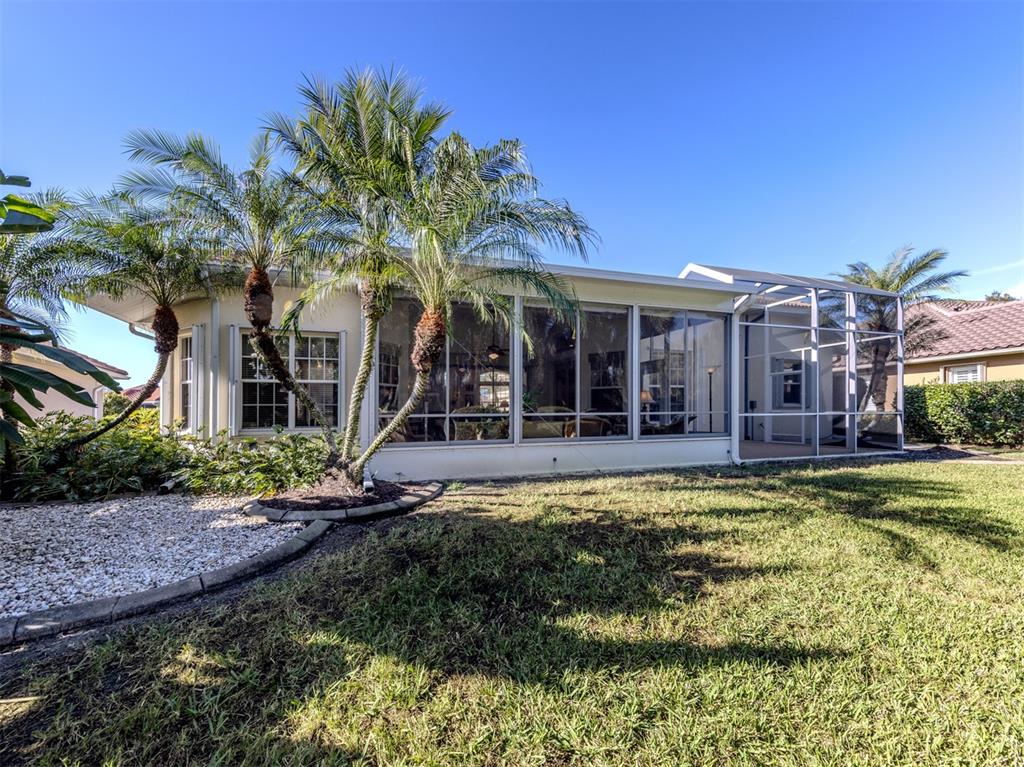 764 Sawgrass Bridge Road Venice, FL 34292 - Photo 29 of 60 a view of a house with swimming pool and a yard