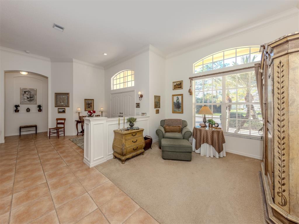 764 Sawgrass Bridge Road Venice, FL 34292 - Photo 3 of 60 a living room with fireplace furniture and a large window