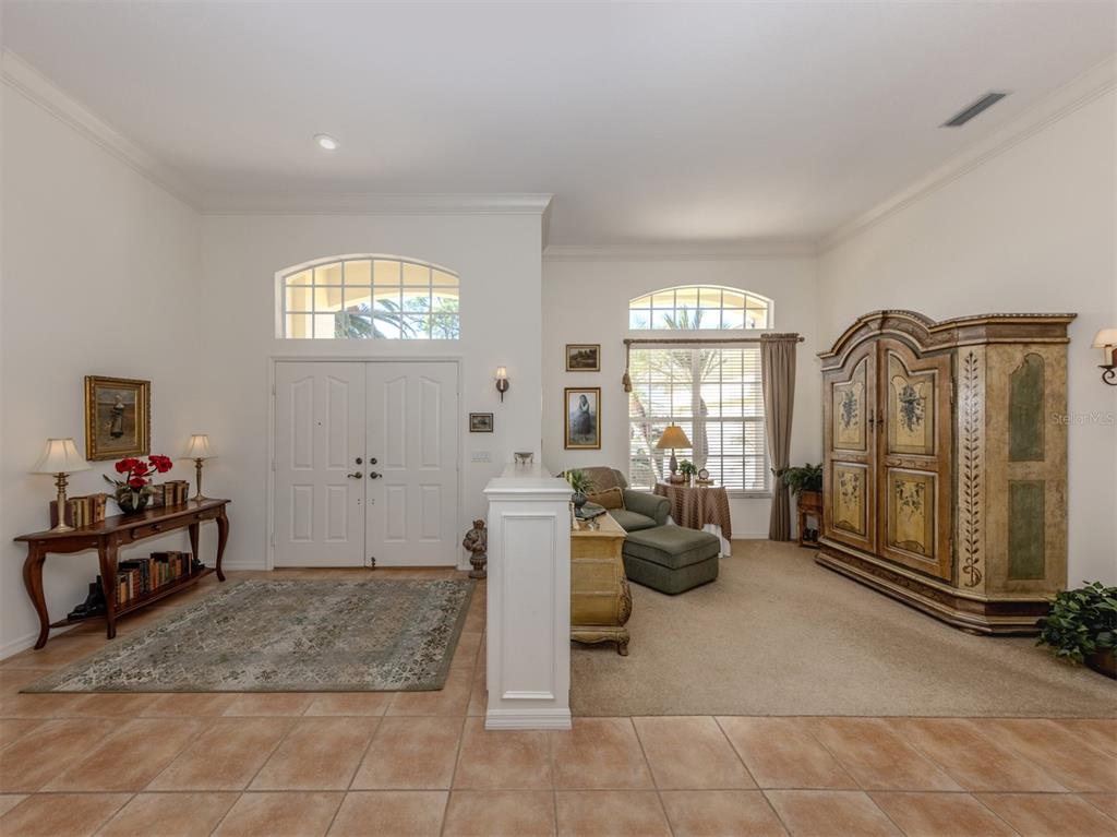 764 Sawgrass Bridge Road Venice, FL 34292 - Photo 4 of 60 a living room with furniture and a large window