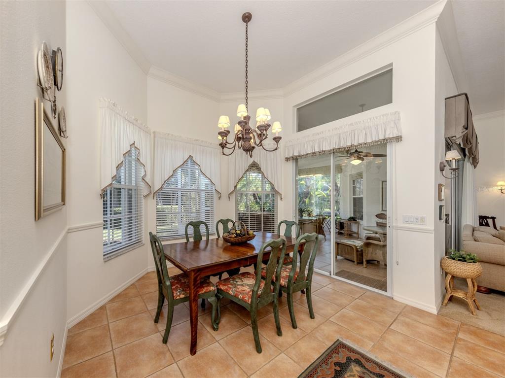 764 Sawgrass Bridge Road Venice, FL 34292 - Photo 8 of 60 a view of a dining room with furniture and chandelier