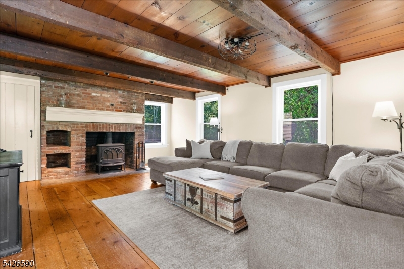 179 Lindbergh Road Hopewell, NJ 08525 - Photo 7 of 46 a living room with furniture fireplace and a large window