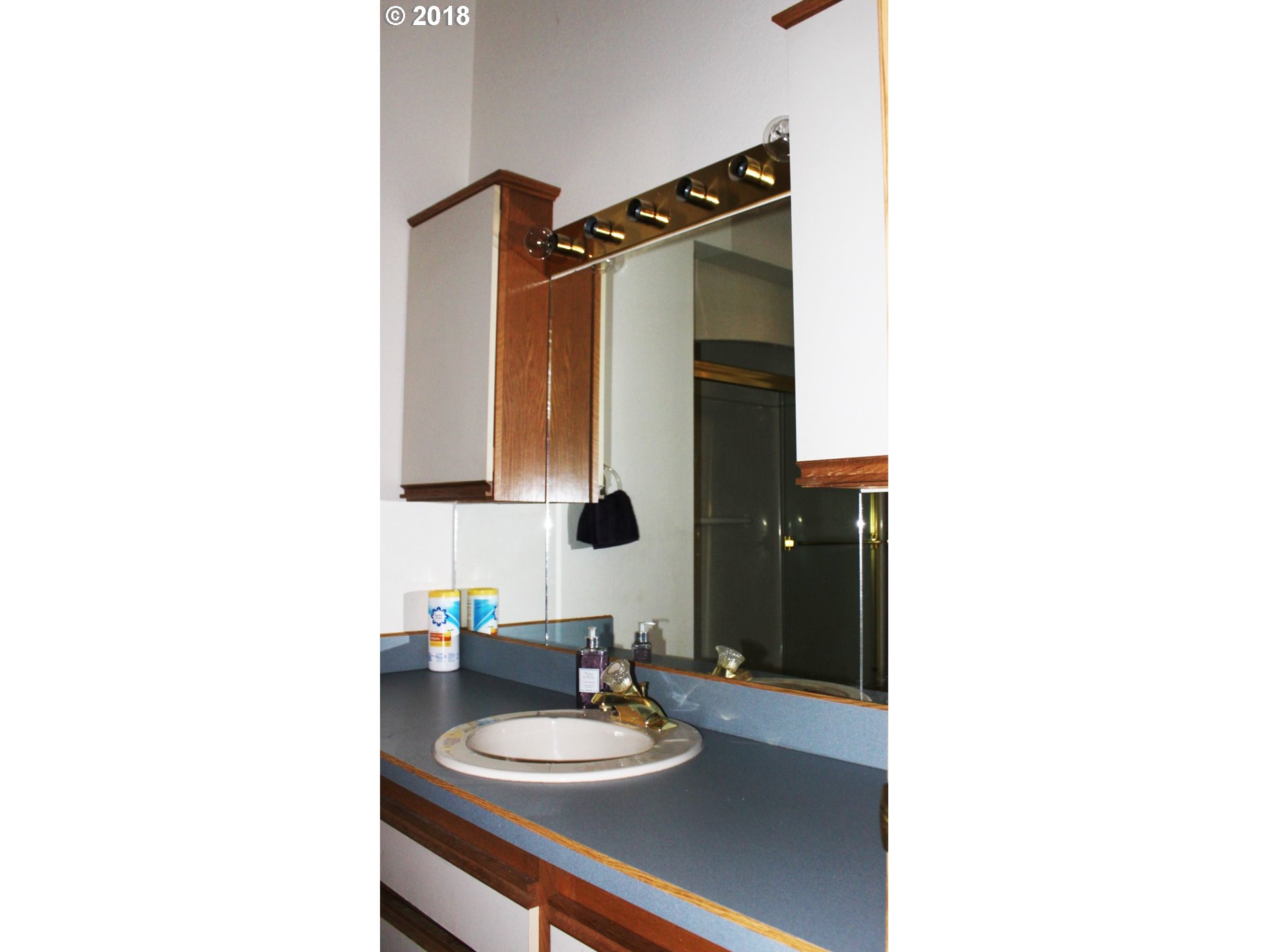 2365 4th Street Baker City, OR 97814 - Photo 13 of 16 a bathroom with a sink and a mirror