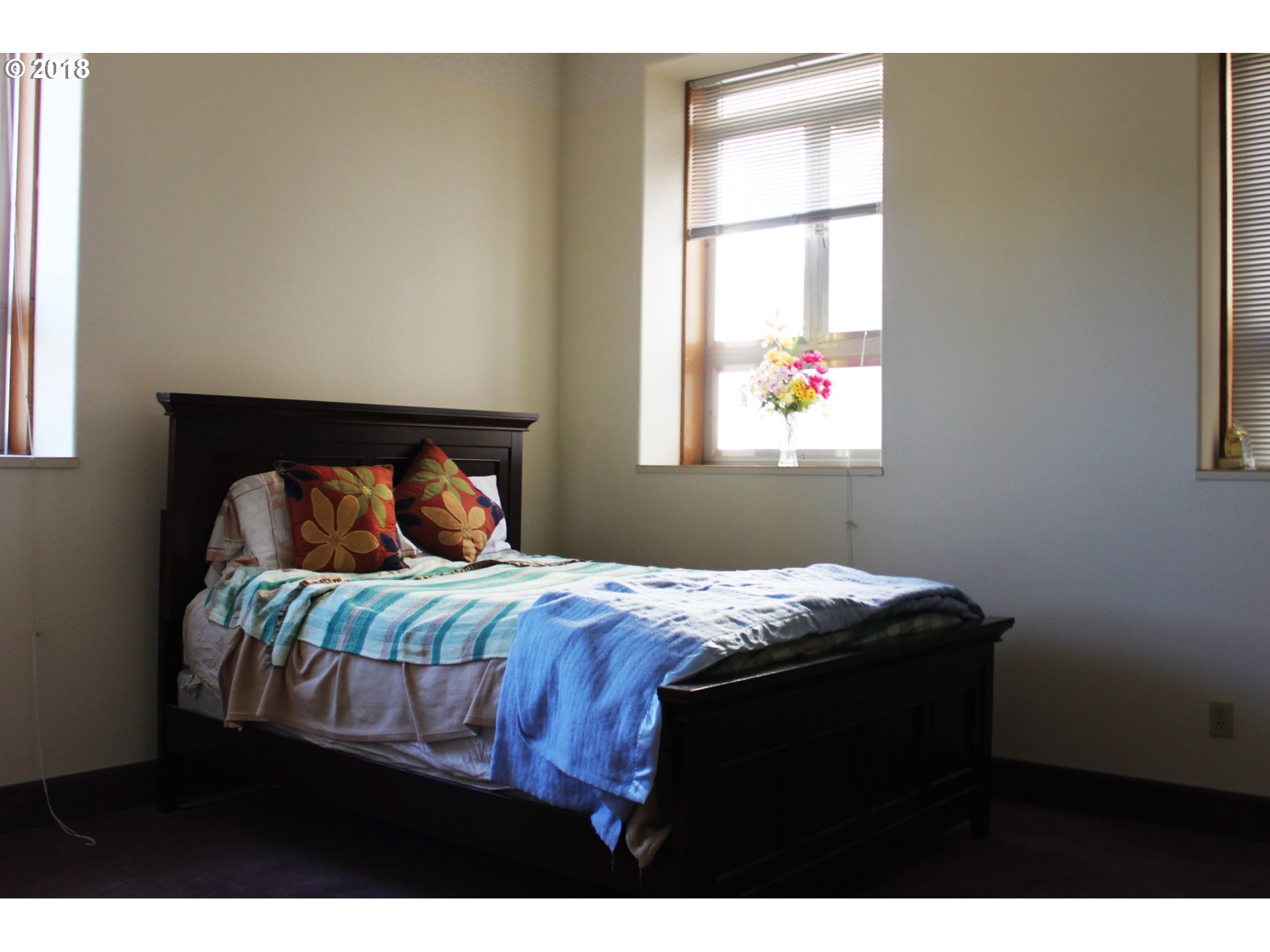 2365 4th Street Baker City, OR 97814 - Photo 15 of 16 a bedroom with a bed and a window