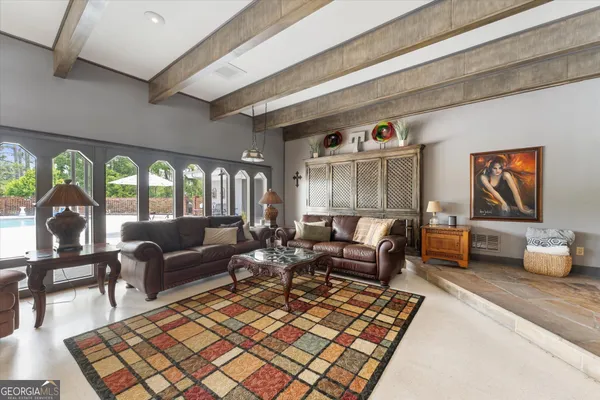 a dining room with furniture a chandelier and fireplace