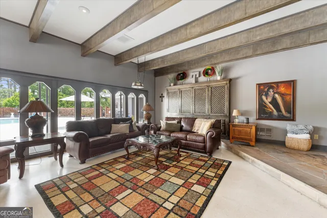 a dining room with furniture a chandelier and fireplace