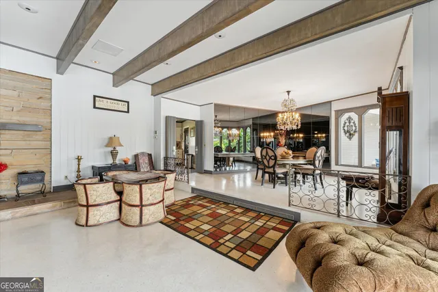 a view of a dining room with furniture a chandelier and wooden floor