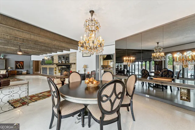 a dining room with furniture a chandelier and wooden floor