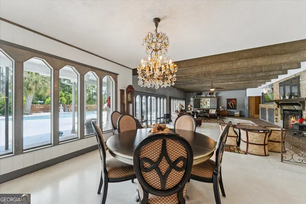a dining room with furniture and wooden floor