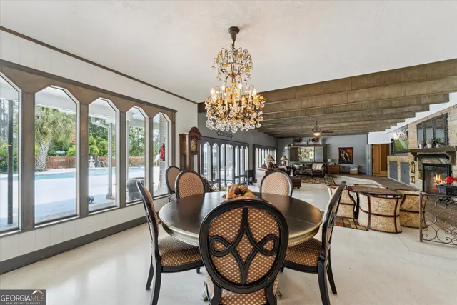 a dining room with furniture and wooden floor