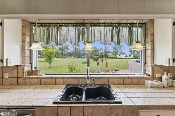 a spacious bedroom with a bed and a lamp