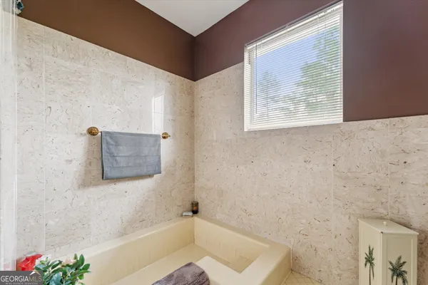 a bedroom with a bed and a view of bedroom