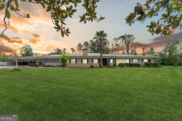 a view of a yard with a house in the background