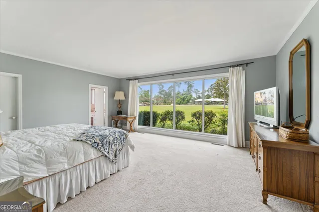 a bedroom with two beds and large window