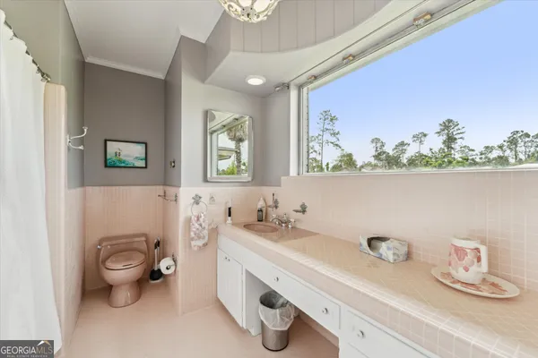 a utility room with cabinets washer and dryer