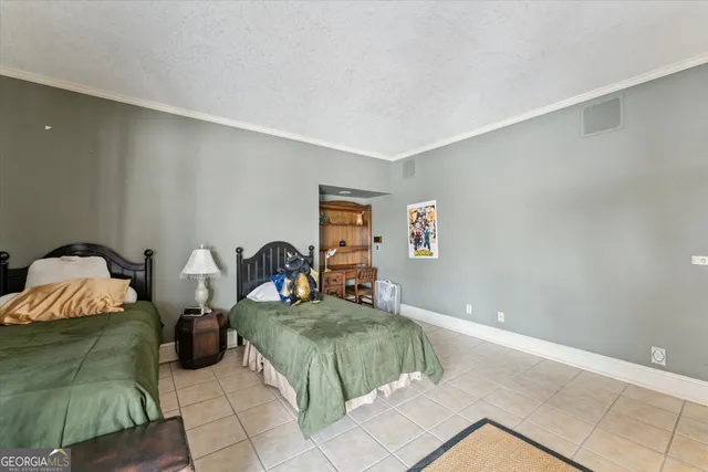 an aerial view of a house with a garden and lake view