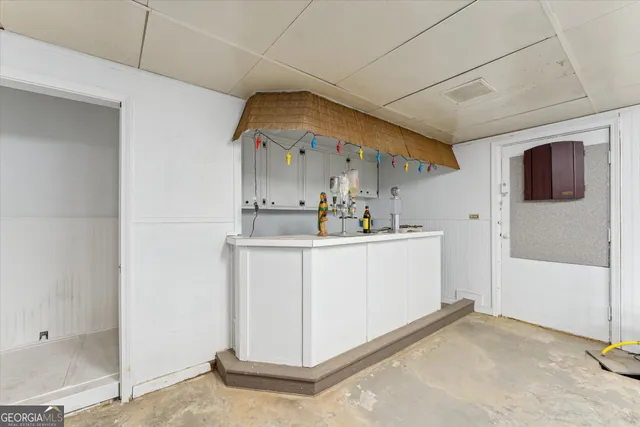 an aerial view of a house a garden and mountain view in back