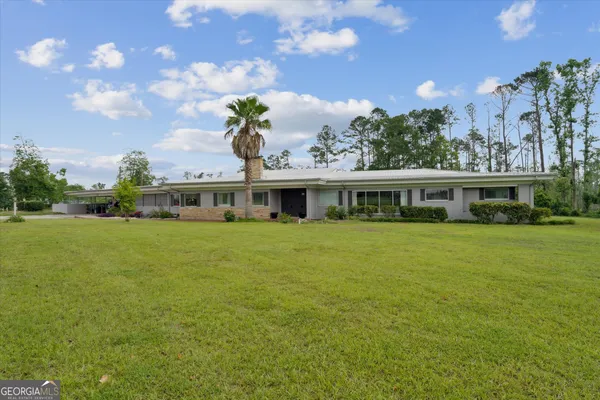 a living room with furniture large window and a table