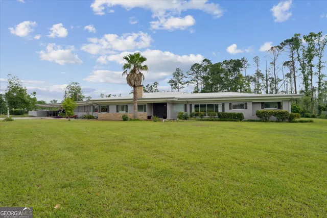 a living room with furniture large window and a table