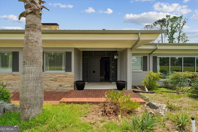 a living room with furniture a rug and a large window