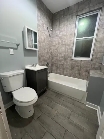 a bathroom with a toilet a sink and bathtub