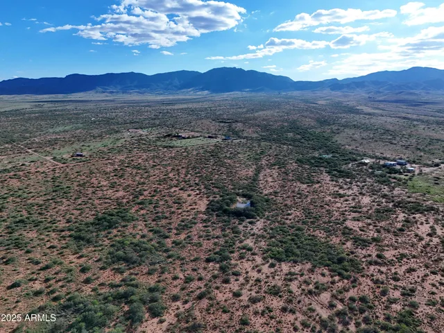 a view of a yard with wooden fence