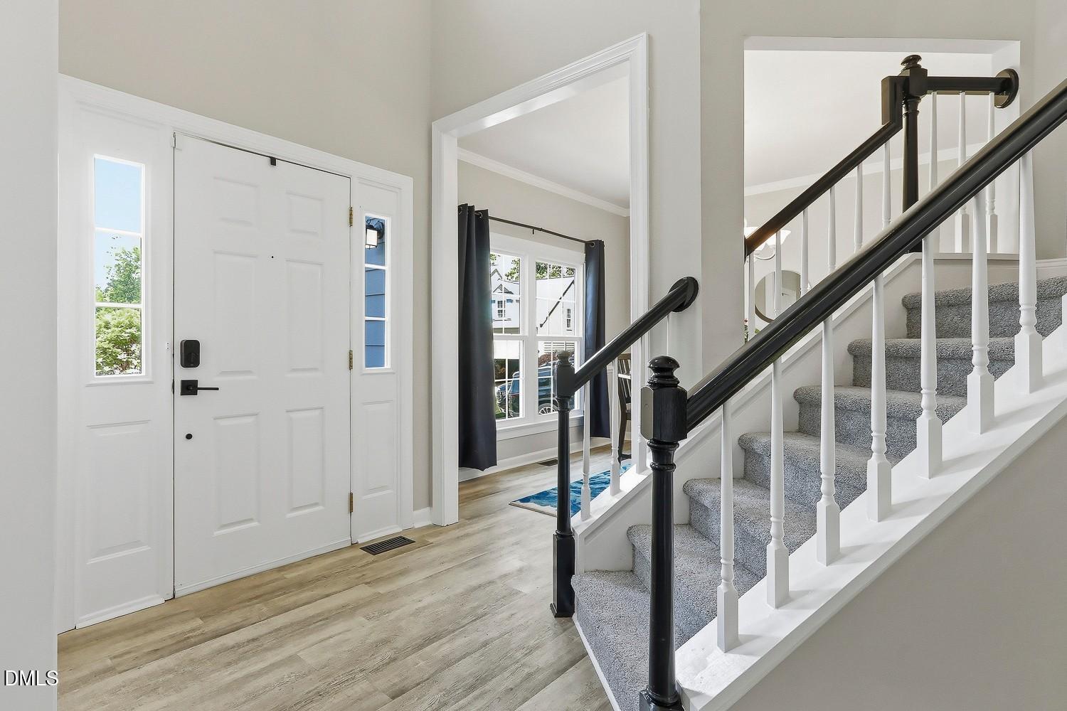 4001 Batiste Road Raleigh, NC 27613 - Photo 6 of 63 a view of an entryway with wooden floor