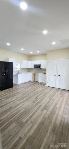 a view of kitchen and refrigerator