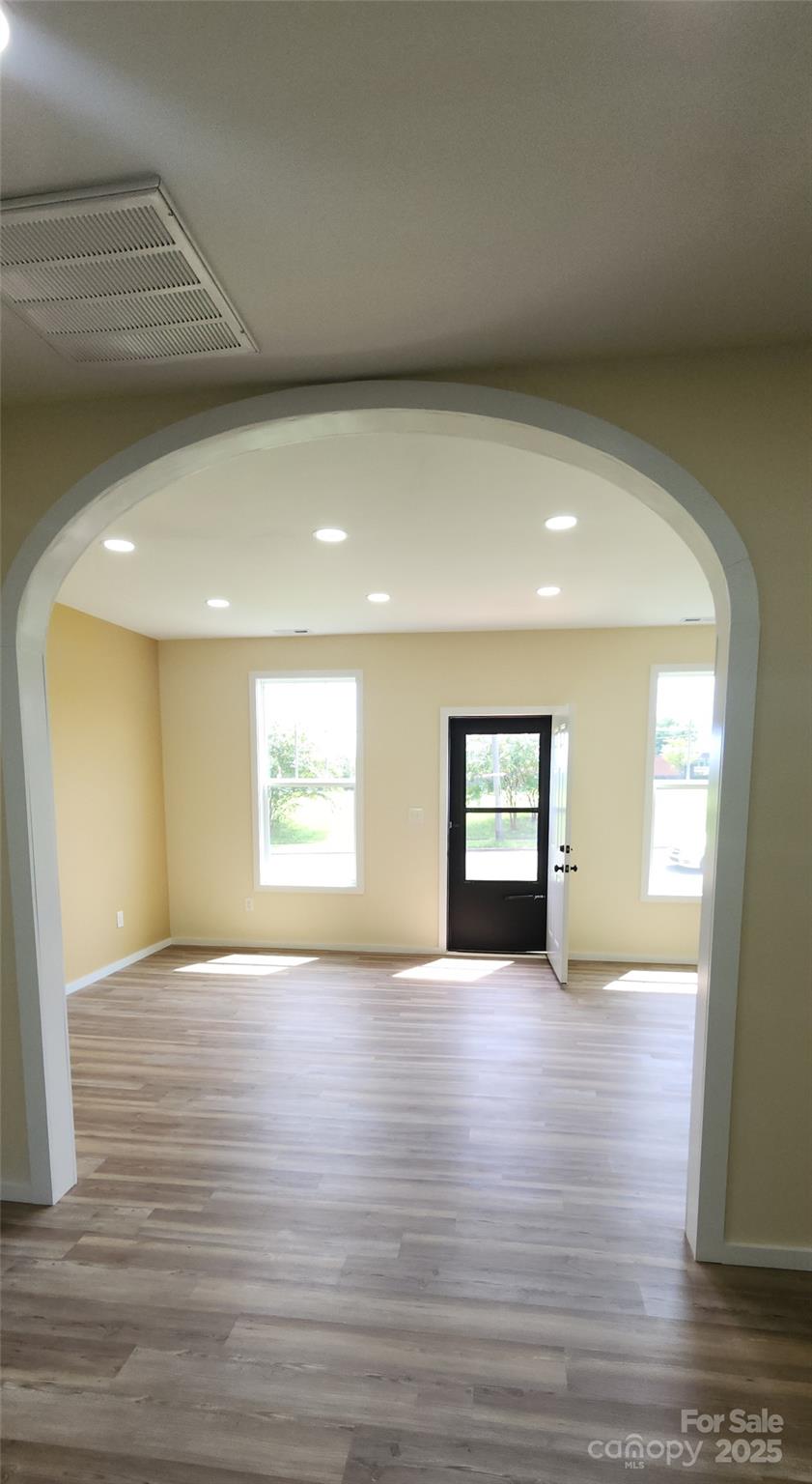 306 Ratchford Avenue Gastonia, NC 28054 - Photo 13 of 28 an empty room with wooden floor and windows