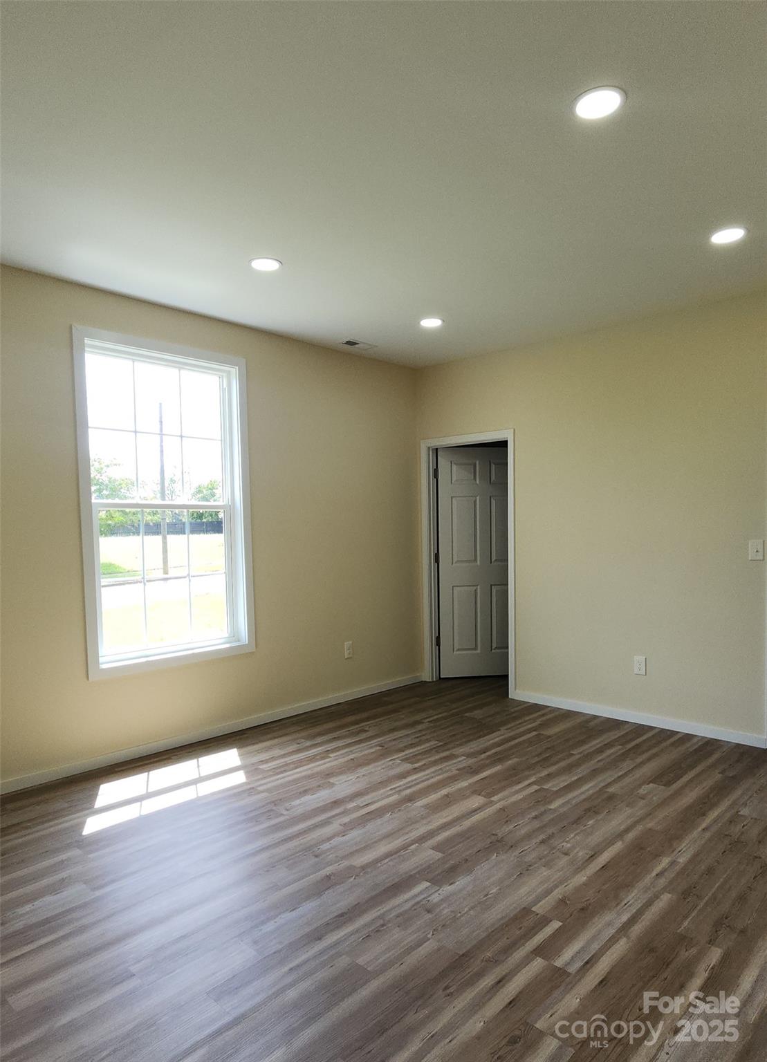 306 Ratchford Avenue Gastonia, NC 28054 - Photo 15 of 28 an empty room with wooden floor and windows