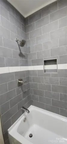 a bathroom with a granite countertop toilet sink and mirror
