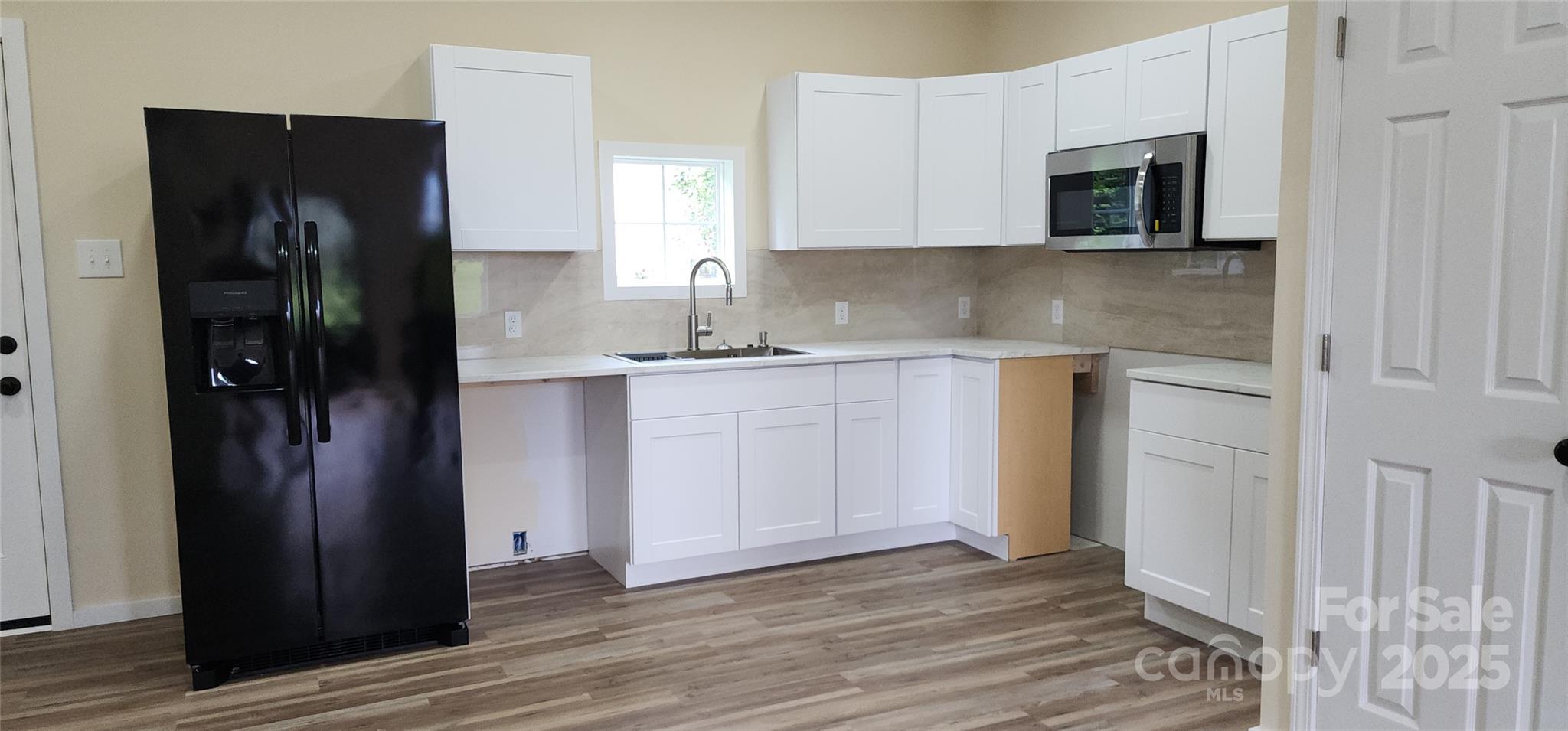 306 Ratchford Avenue Gastonia, NC 28054 - Photo 3 of 28 a kitchen with stainless steel appliances granite countertop a refrigerator and a stove top oven