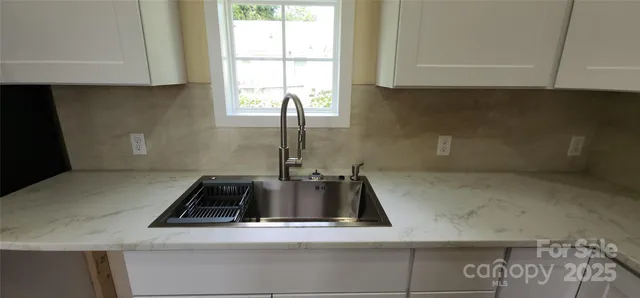 a kitchen with a sink and cabinets