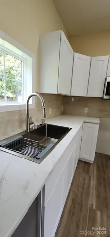 a kitchen with a sink cabinets and window