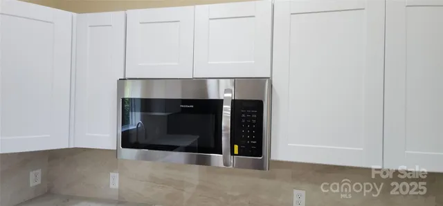a living room with a fireplace and a rug