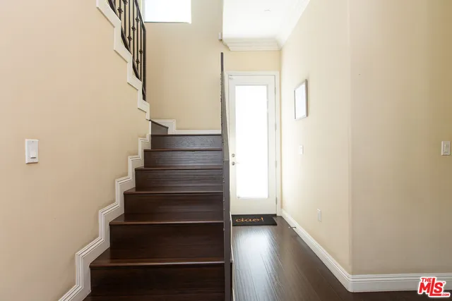 a view of entryway and gallery with wooden floor