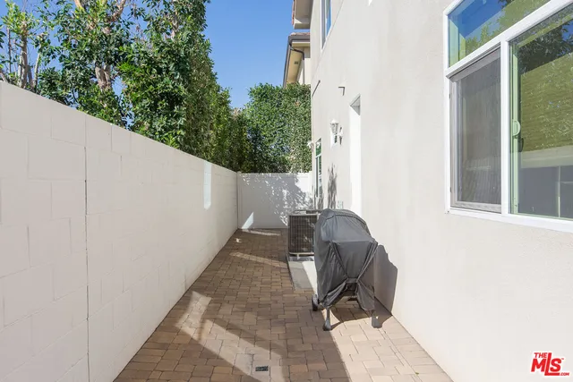 a balcony with table and chairs