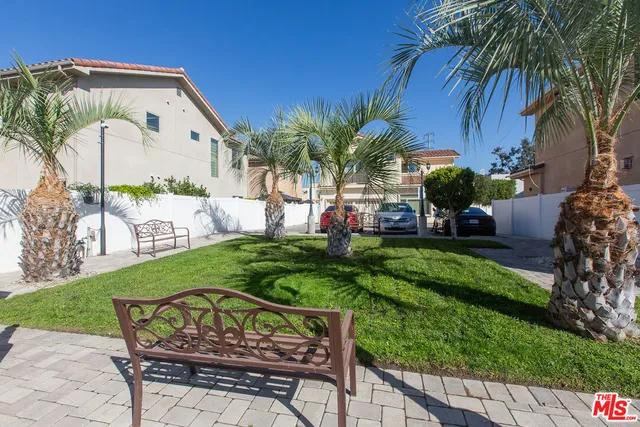 a view of a chair and table in the garden