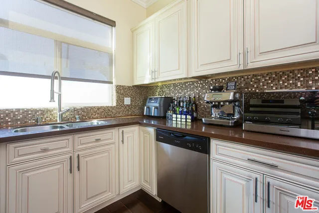 a kitchen with granite countertop white cabinets and a stove