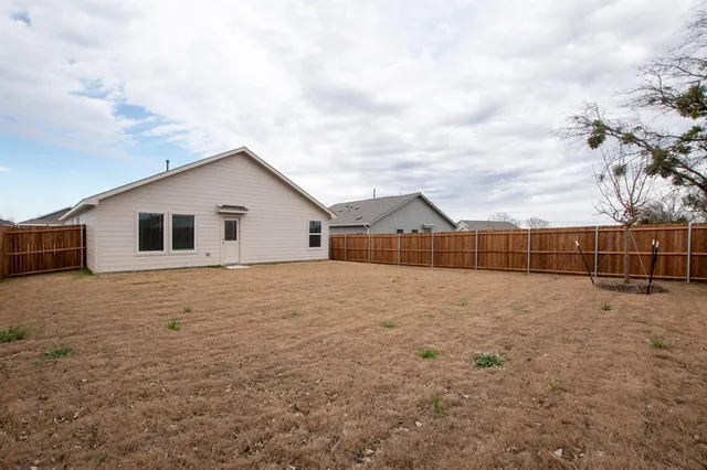 a view of a house with wooden fence