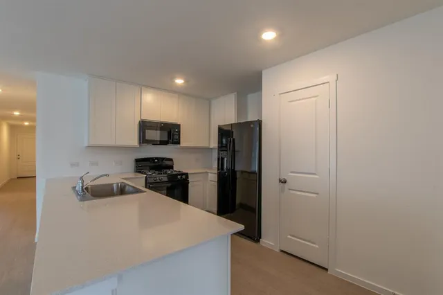 a kitchen with a refrigerator and a sink