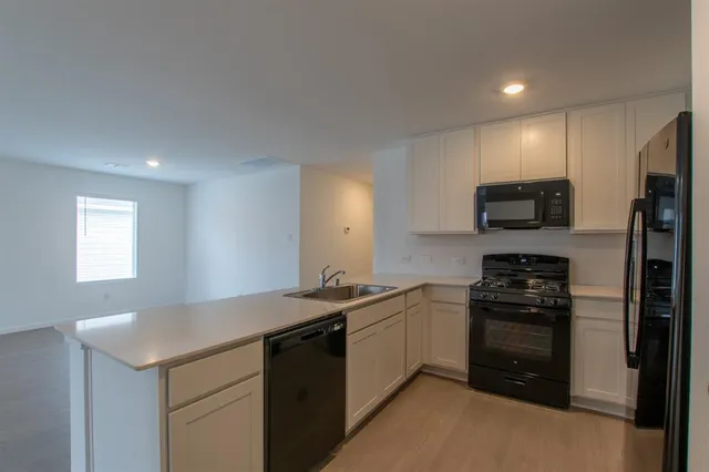 a kitchen with a sink a stove and refrigerator