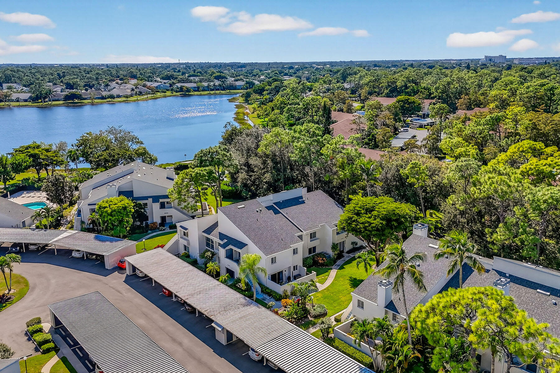an aerial view of a house with a garden and lake view