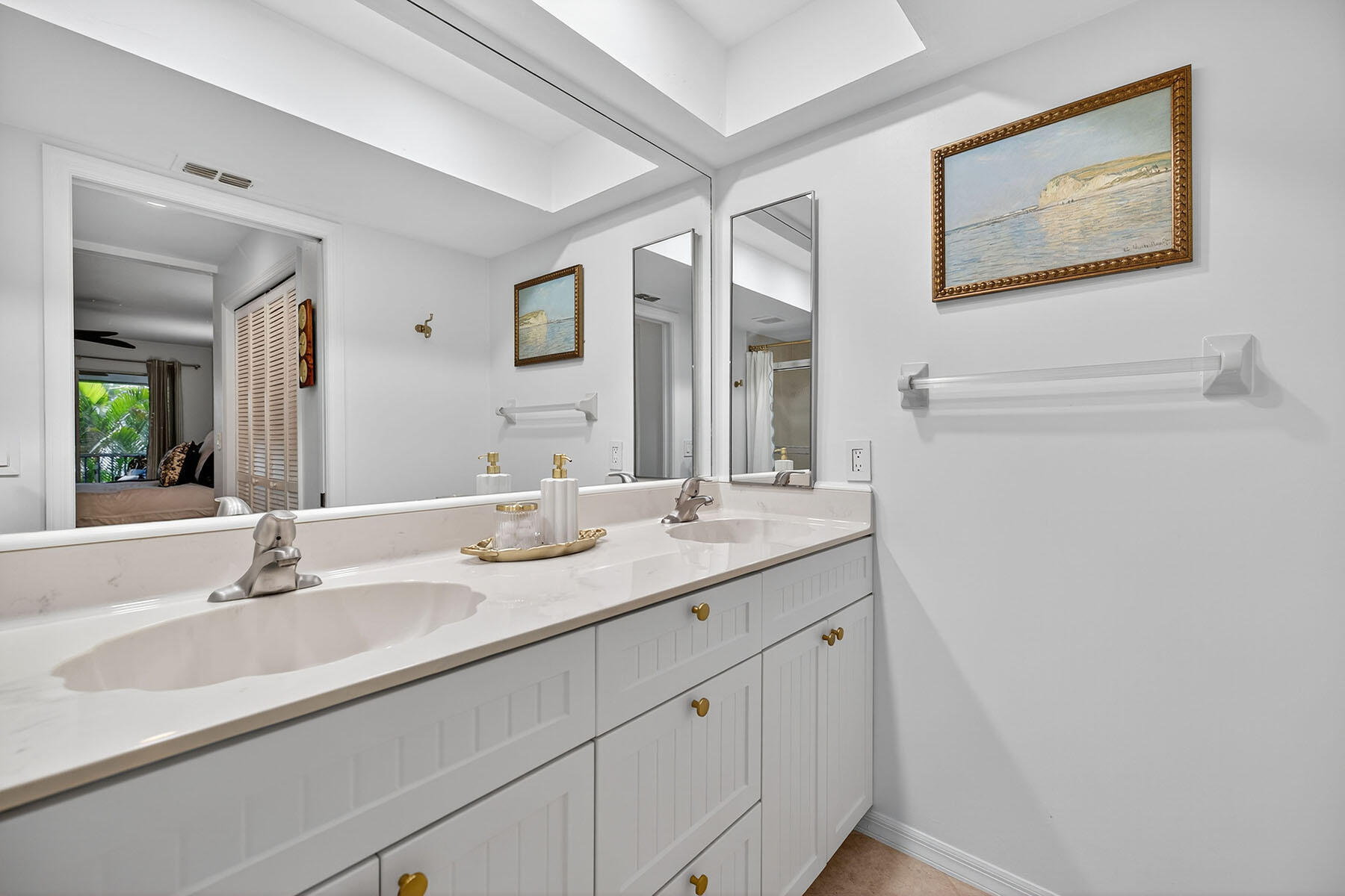 3136 Kings Lake Boulevard, Unit 7546 Naples, FL 34112 - Photo 17 of 32 a bathroom with a sink and a mirror